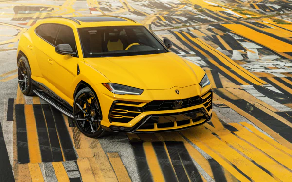 Bright yellow Lamborghini Urus SUV on a stylized yellow-and-black patterned surface, 8K Ultra HD PC desktop wallpaper.