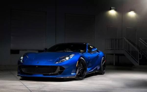 Sleek blue Ferrari 812 Superfast grand tourer and supercar showcased in a dimly lit urban setting, captured as an HD PC desktop wallpaper and background.