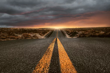 A man-made road stretches through a rugged landscape under dramatic clouds, captured in HD for a vivid desktop wallpaper and background.