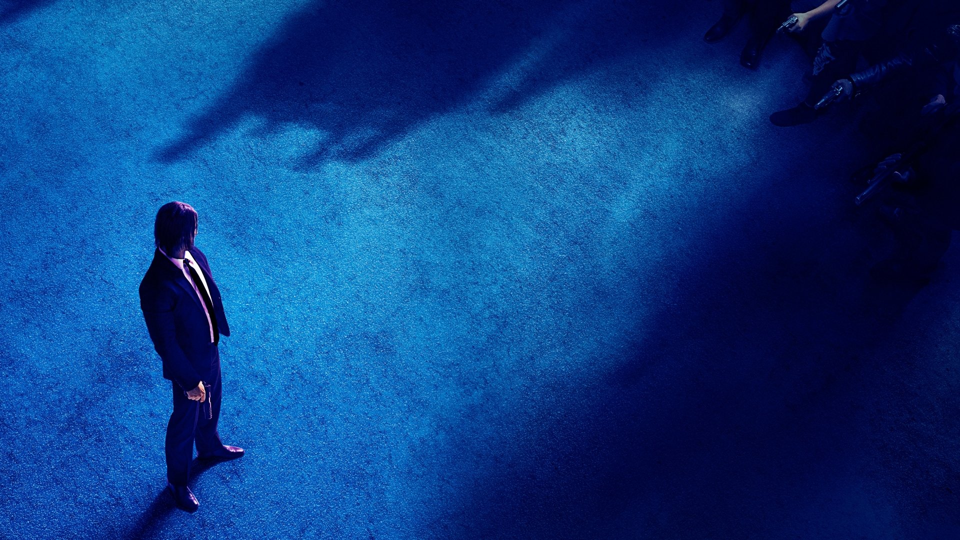 HD desktop wallpaper featuring Keanu Reeves as John Wick in John Wick: Chapter 3 - Parabellum, standing alone on a blue floor with shadows surrounding him.