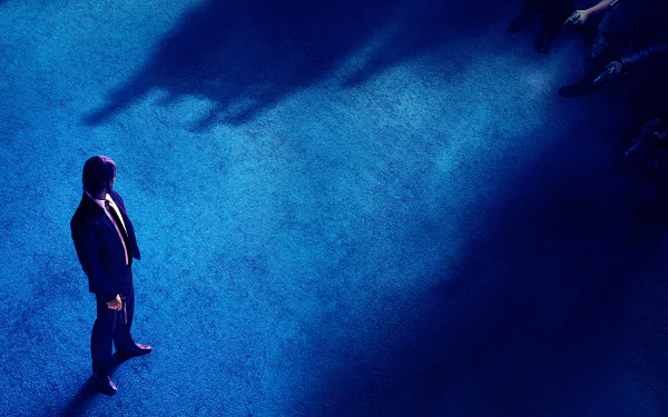 HD desktop wallpaper featuring Keanu Reeves as John Wick in John Wick: Chapter 3 - Parabellum, standing alone on a blue floor with shadows surrounding him.