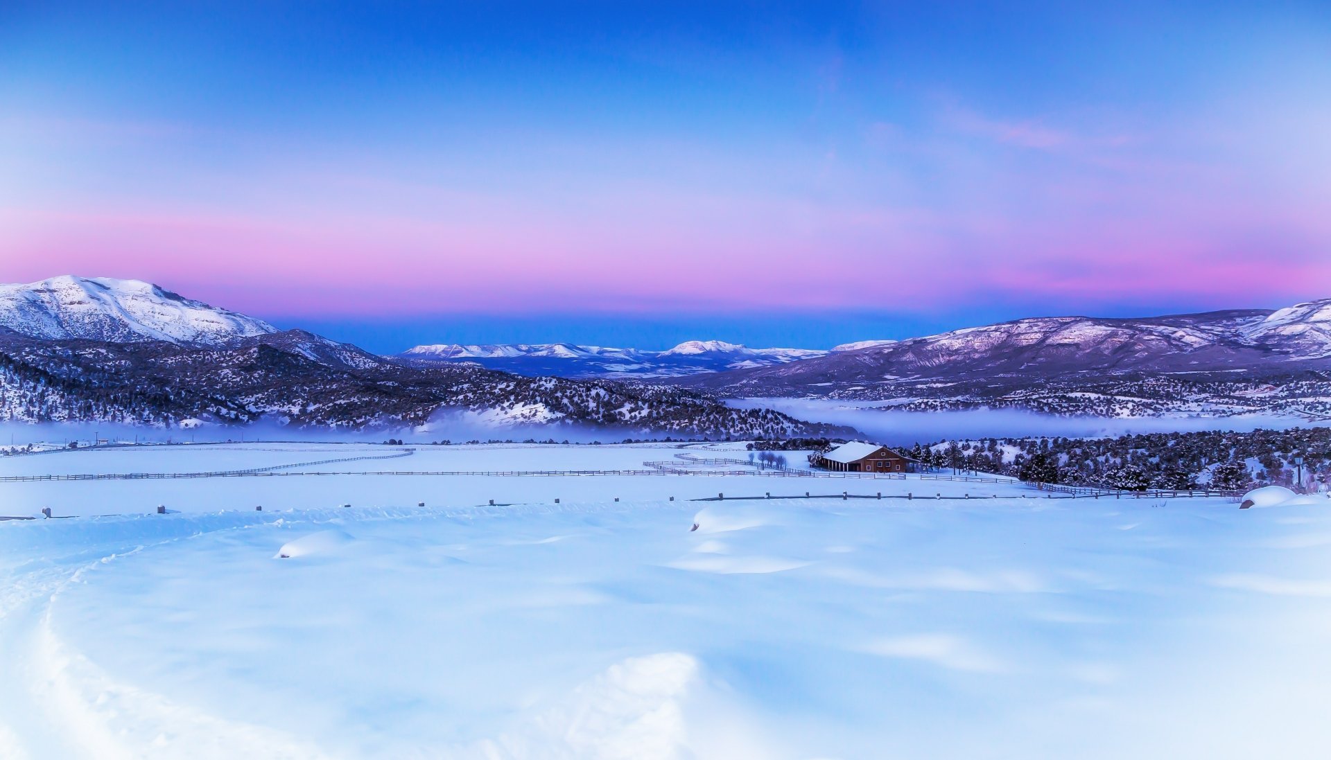 4K Ultra HD photography of a serene winter landscape with snow-covered mountains and a pastel sky, captured as a PC desktop wallpaper and background.