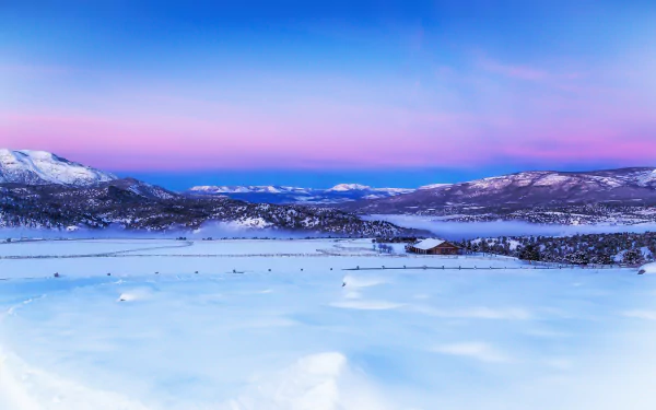 4K Ultra HD photography of a serene winter landscape with snow-covered mountains and a pastel sky, captured as a PC desktop wallpaper and background.