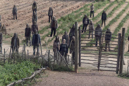 Alpha and The Whisperers stand behind a crude wooden gate in a field, a grim group from The Walking Dead TV show — 4K Ultra HD PC desktop wallpaper