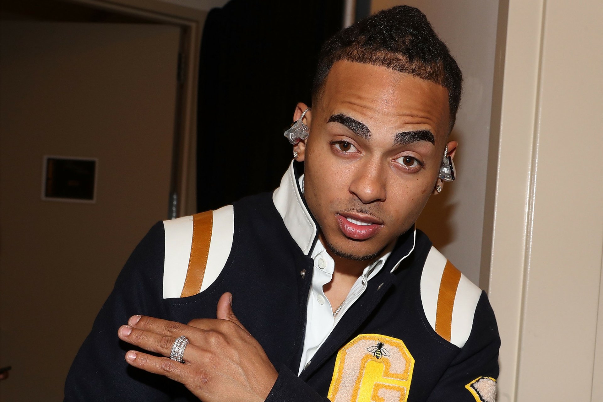HD desktop wallpaper featuring a man in a varsity jacket posing for the camera, tagged as Ozuna.